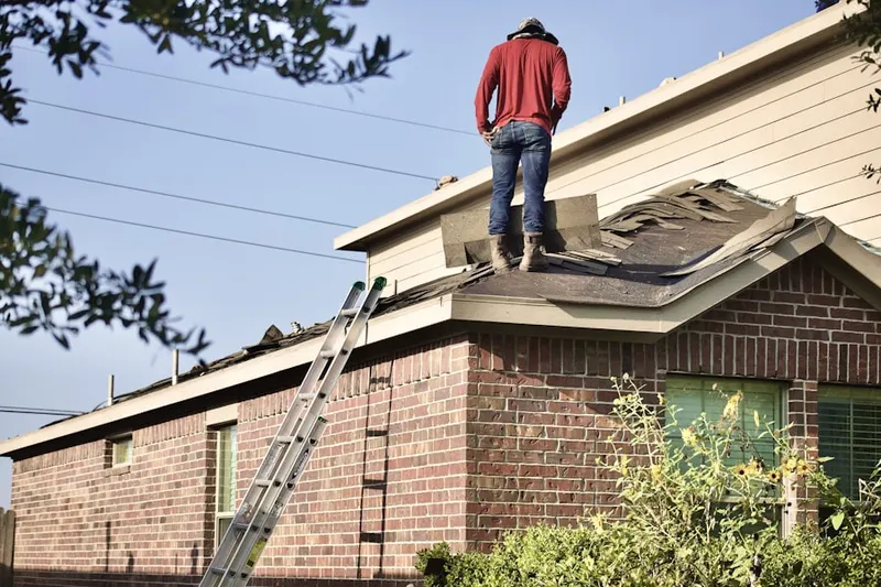 Professional roofer working on a residential roof in Stonewall Manor Estates